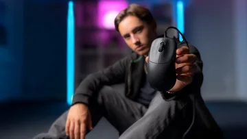Person holding the actual CHERRY XTRFY M42V2 wired gaming mouse