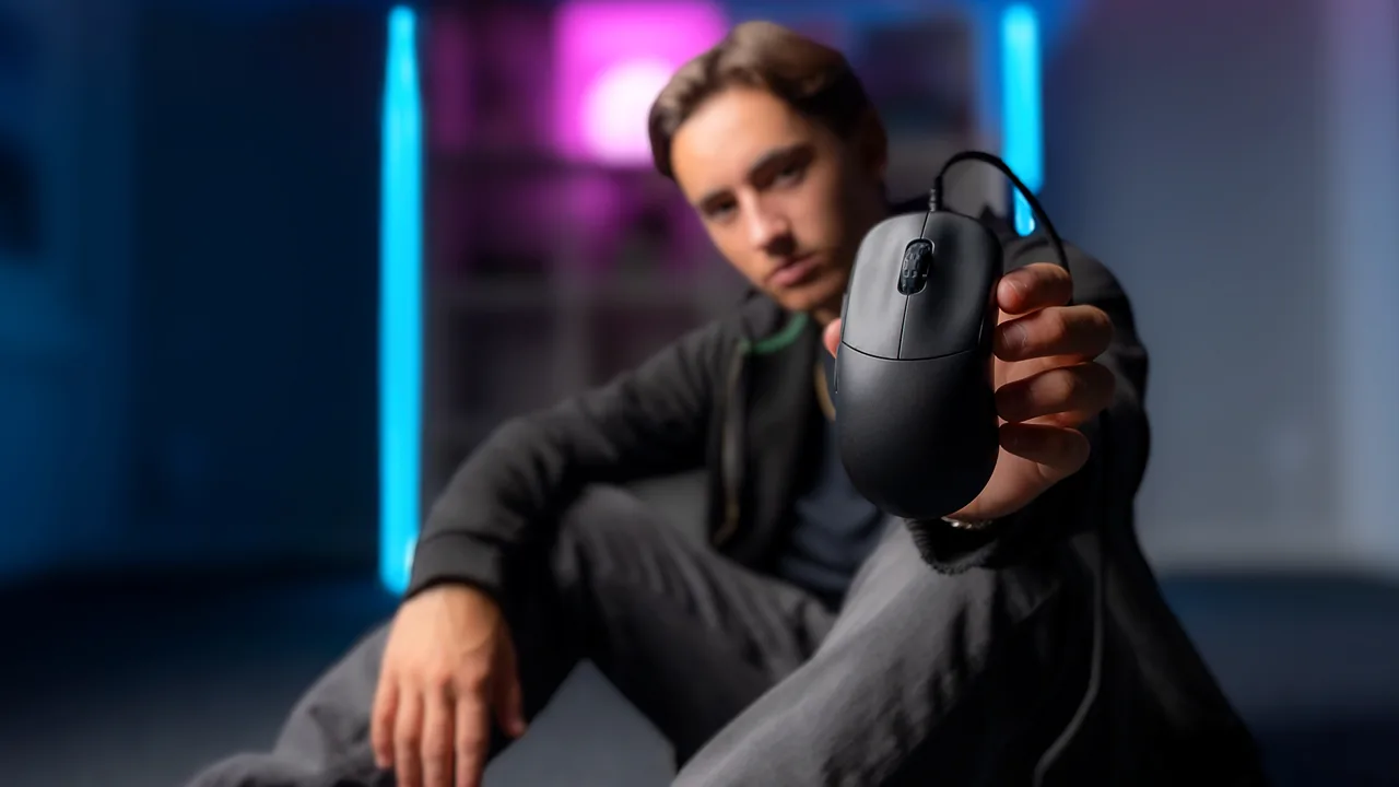 Person holding the actual CHERRY XTRFY M42V2 wired gaming mouse