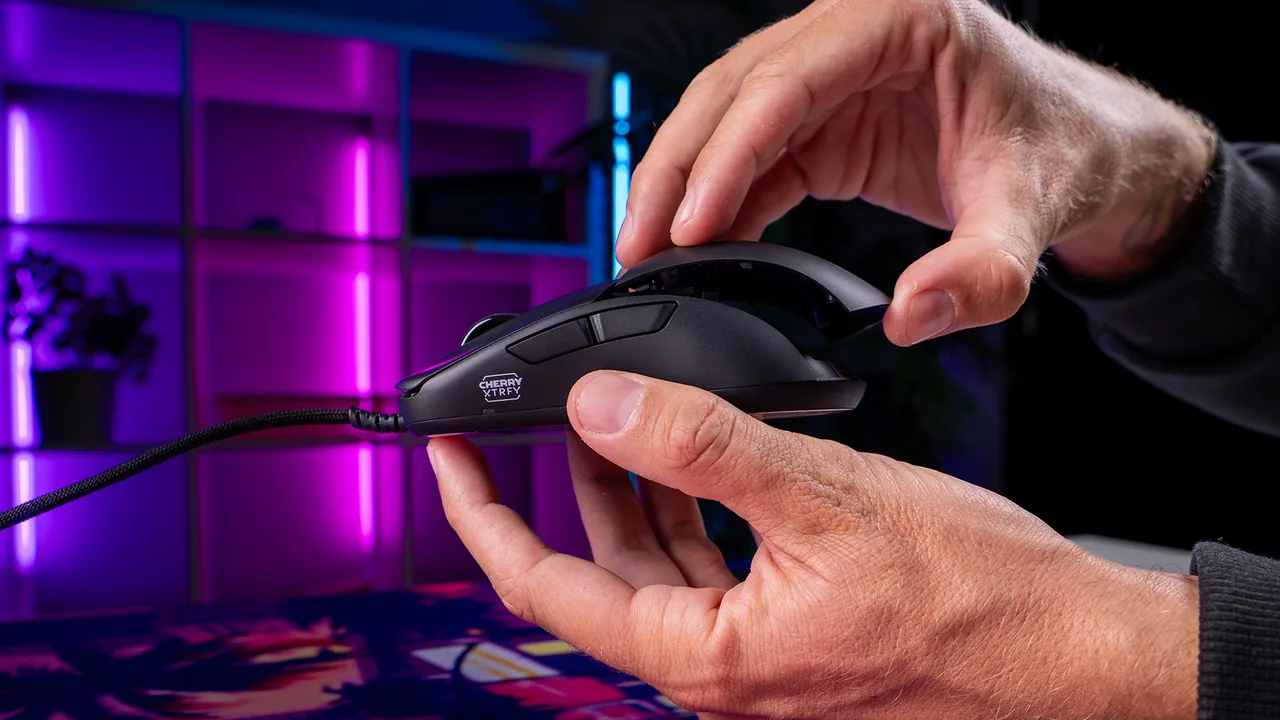 Hands removing the rear shell from an actual CHERRY XTRFY M42V2 mouse