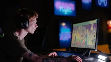 A gamer checking fast motion on a monitor before tuning overdrive and ghosting settings