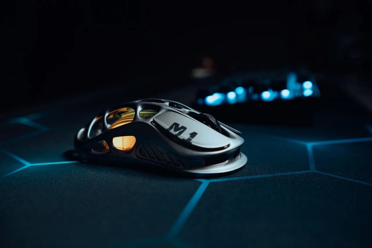 Sleek metallic gaming mouse on an esports mousepad — used for testing 1-to-1 sensor tracking after disabling acceleration