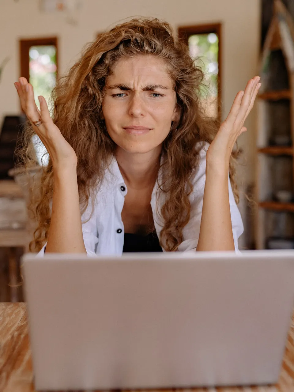 Publisher looking frustrated while troubleshooting a laptop issue