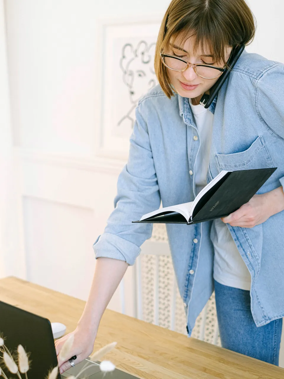 Publisher making a support call beside a laptop and notebook