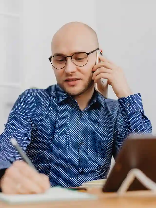 Illustrative stock photo of a man writing notes while speaking on a phone