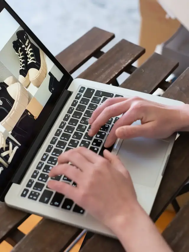 Hands typing on a laptop keyboard during a delivery-day check
