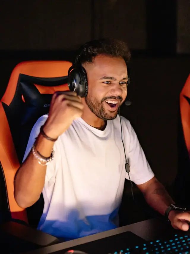 The white-shirt gamer raising a fist at his computer; posed stock illustration of a changed comparison outcome