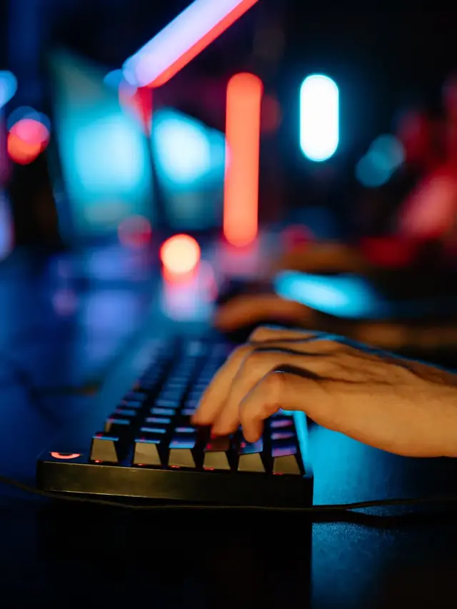 Close-up of a hand operating a gaming keyboard; stock illustration of checking the reload action