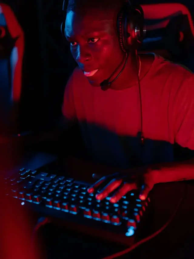 A gamer entering keyboard commands at a computer; illustrative stock for trying a configuration