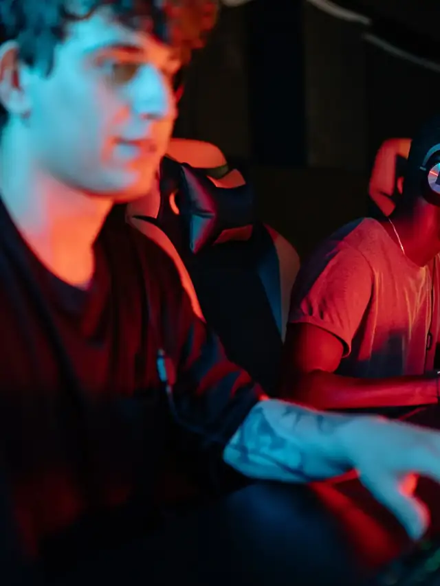 Headset-wearing player remapping controls at a gaming computer