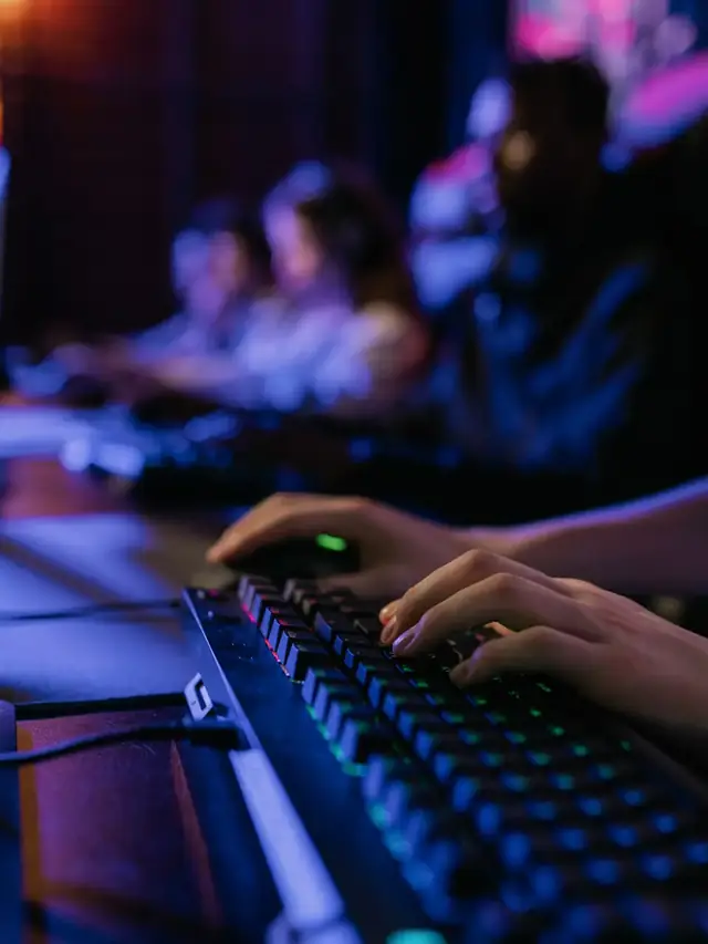 Hands pressing several keys on a mechanical gaming keyboard