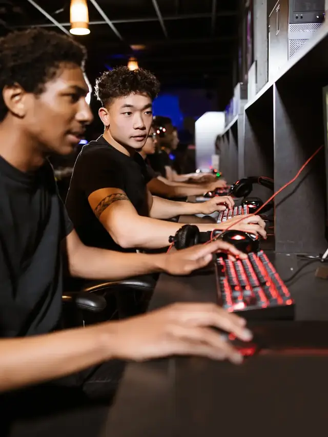 Row of players testing keyboard settings at gaming computers