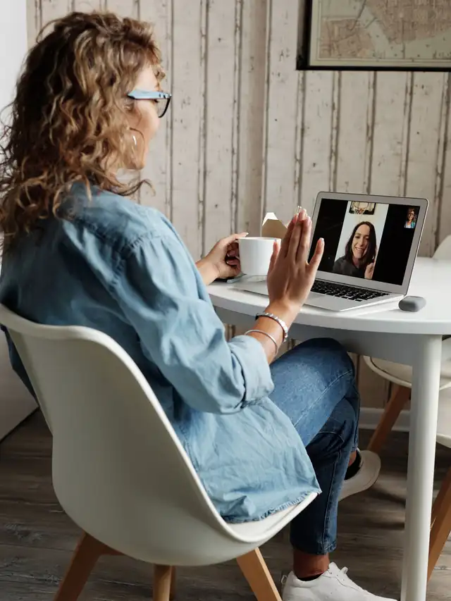 Woman joining a video call on a laptop at a desk