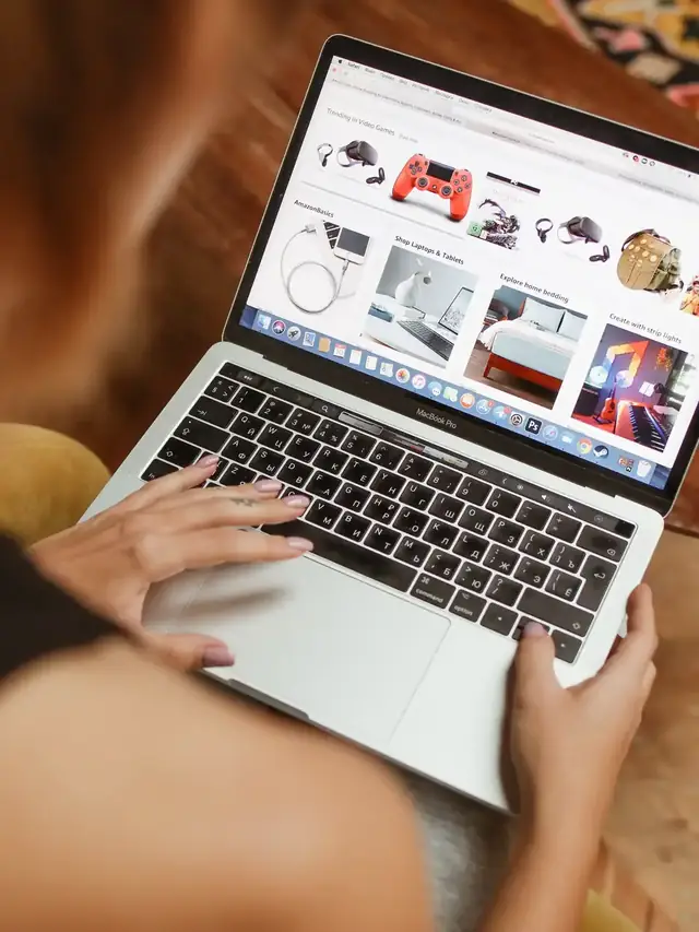 Online shopper comparing products while typing on a laptop