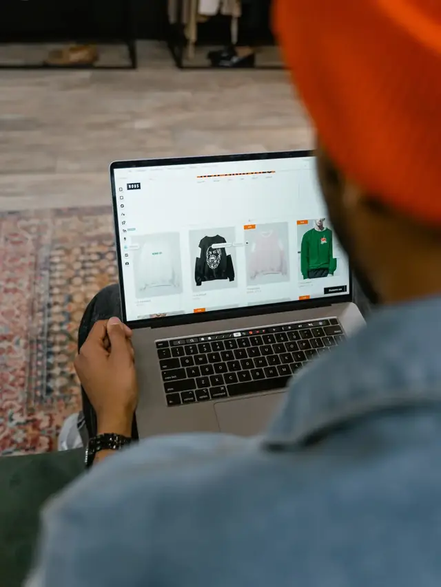 Shopper using a laptop keyboard while viewing product listings