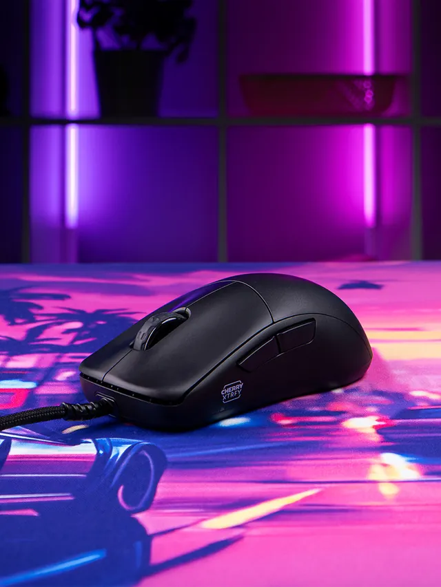CHERRY XTRFY M42V2 wired mouse resting on a colorful synthwave desk mat