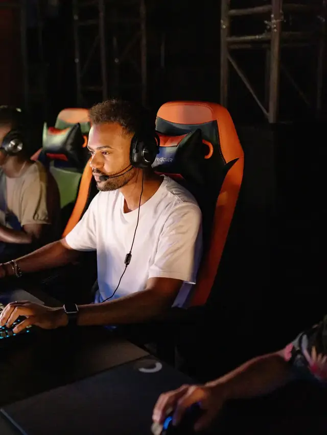 Row of gamers using keyboards during an esports session