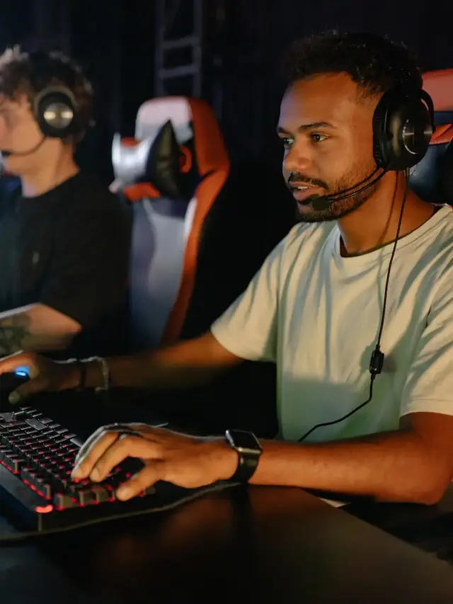Focused gamer using a keyboard and mouse in an esports room