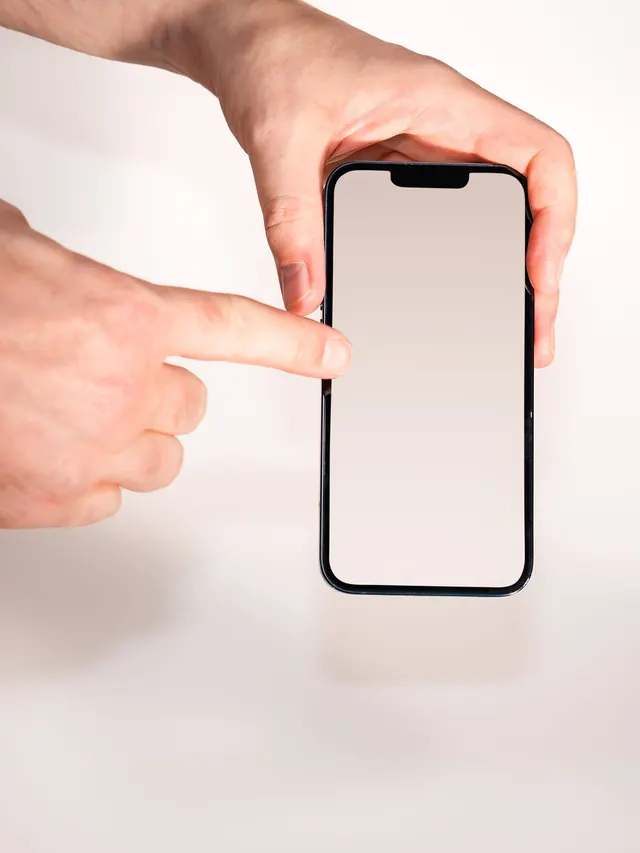Hands pointing to a blank smartphone screen where a display setting would be selected