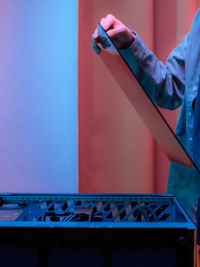 Man lowering the side panel onto a finished PC build