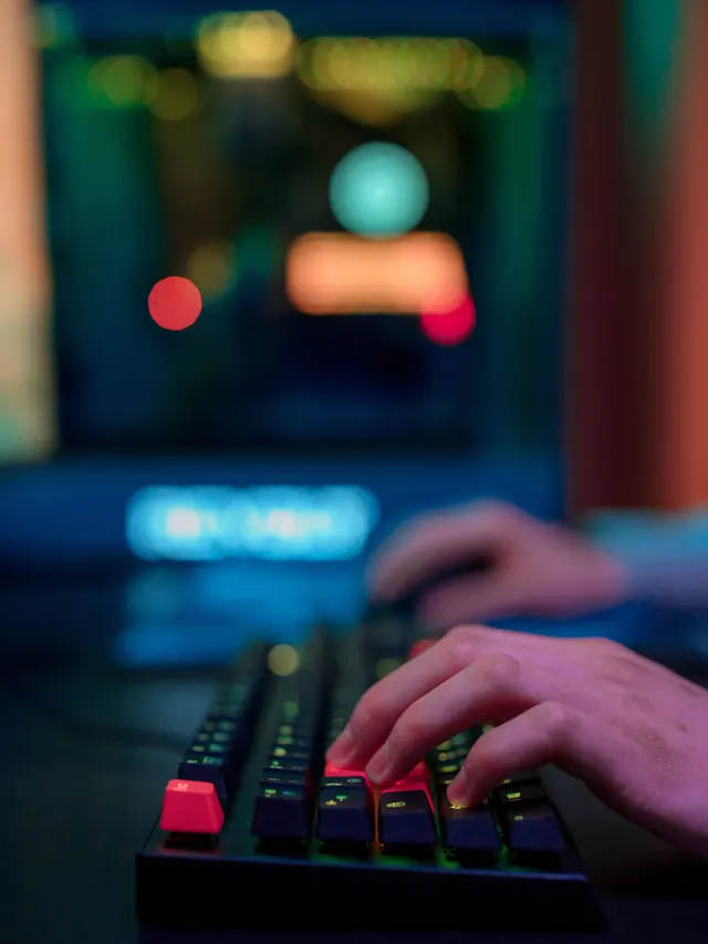 Hands testing movement keys on a compact mechanical keyboard