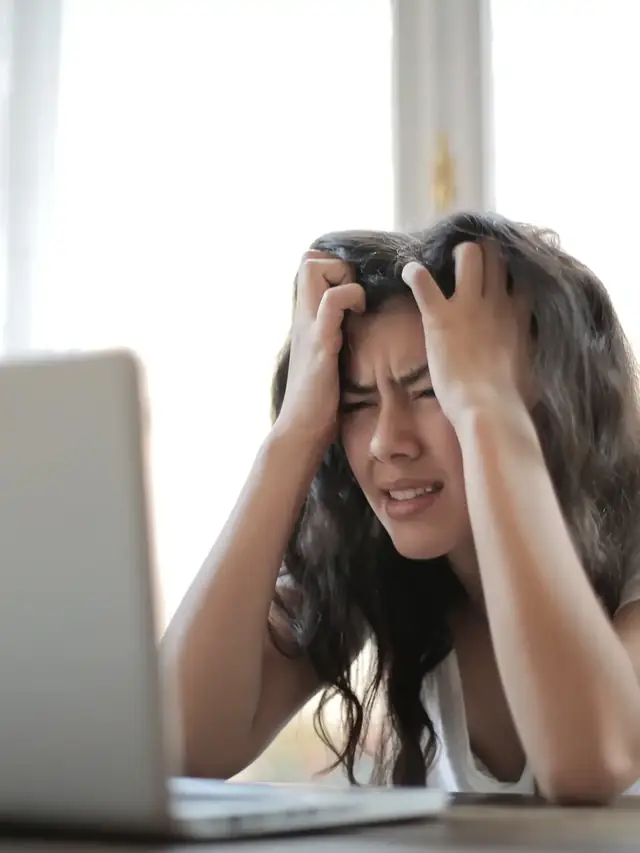 Woman retesting a laptop while watching the screen closely