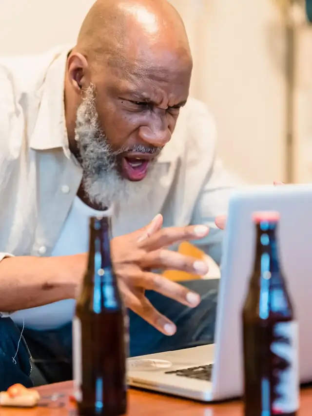 Frustrated man reacting to a repeated problem on a laptop