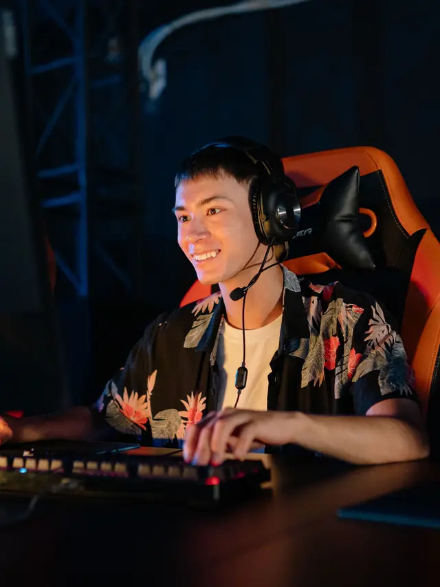 A gamer operating a mouse beside a keyboard; stock illustration of reaching controls during play