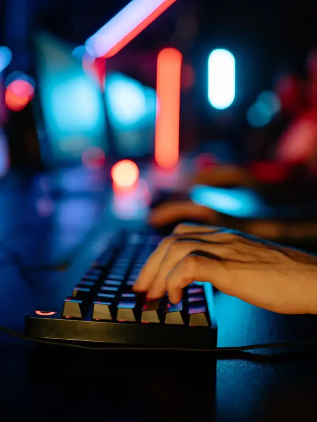 A close view of a hand on a gaming keyboard; stock illustration of input events, not a hardware timing measurement