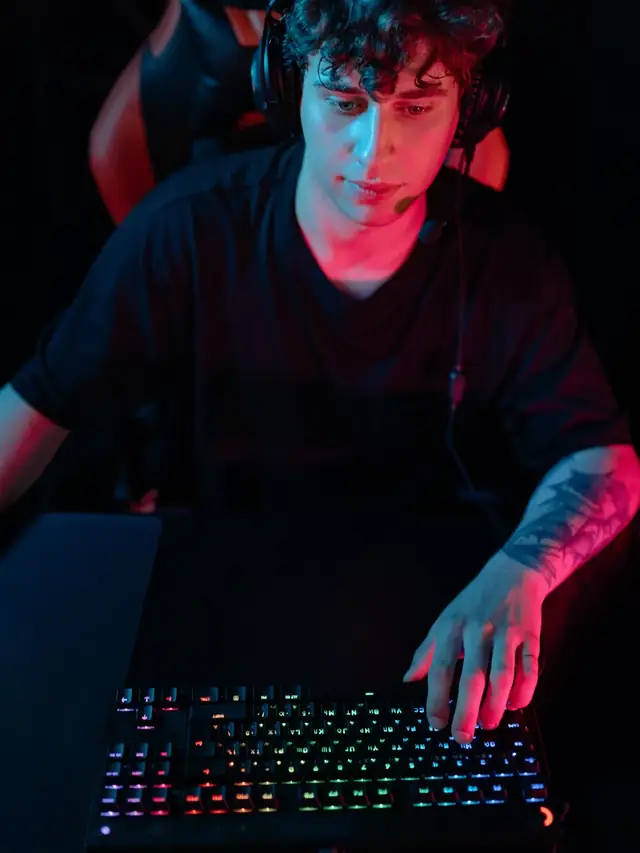 A gamer using a keyboard at a computer; stock illustration of checking the control scheme in the actual game