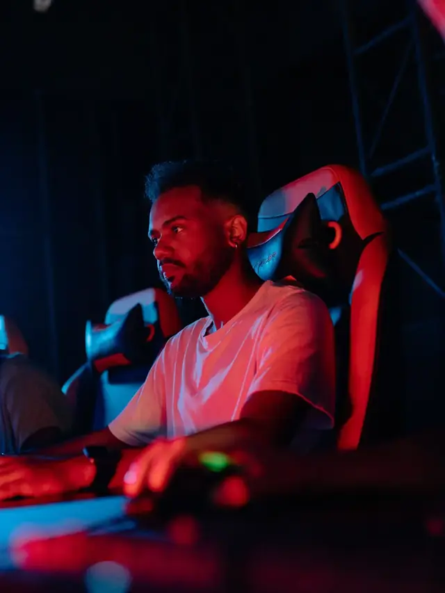 A gamer using a computer in a gaming room; stock illustration of testing a complete control scheme in a game
