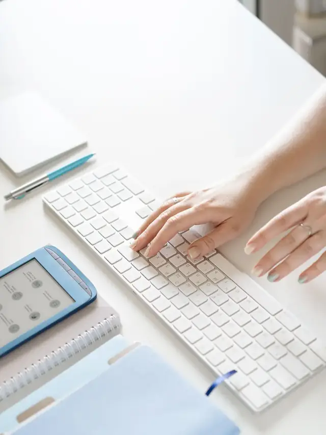 Hands using a white generic keyboard; stock illustration of checking a keyboard layout, not the split Wooting model