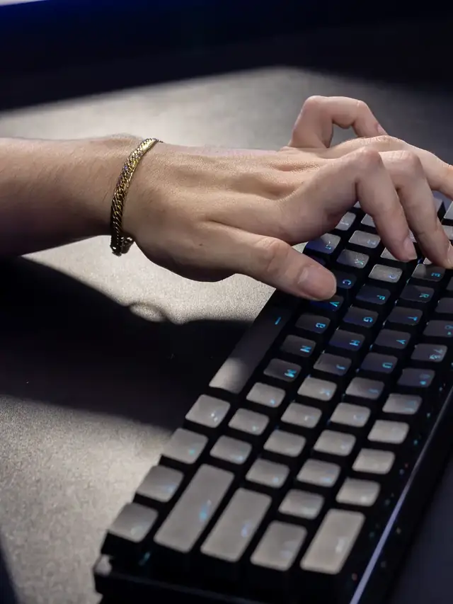 Hands pressing keys on a generic mechanical keyboard; stock illustration of practical input testing