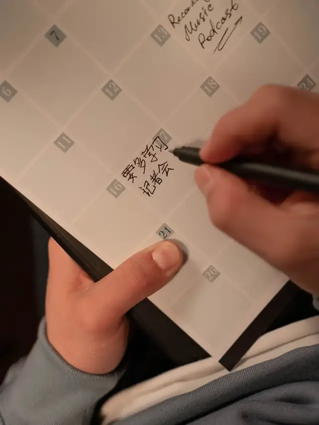 Hands writing on a paper calendar; stock illustration of planning a preorder timeline