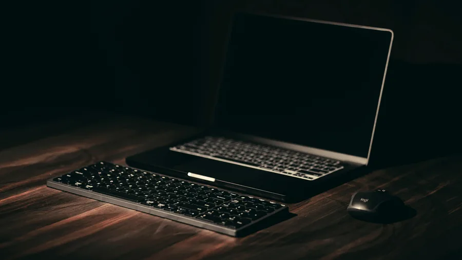 Laptop, keyboard and mouse on a wooden desk