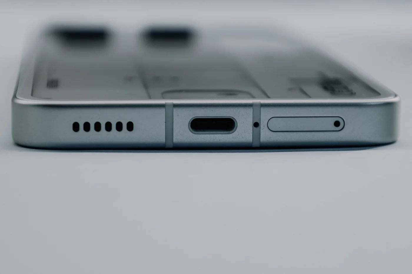 Close-up of a smartphone speaker grille and USB-C port